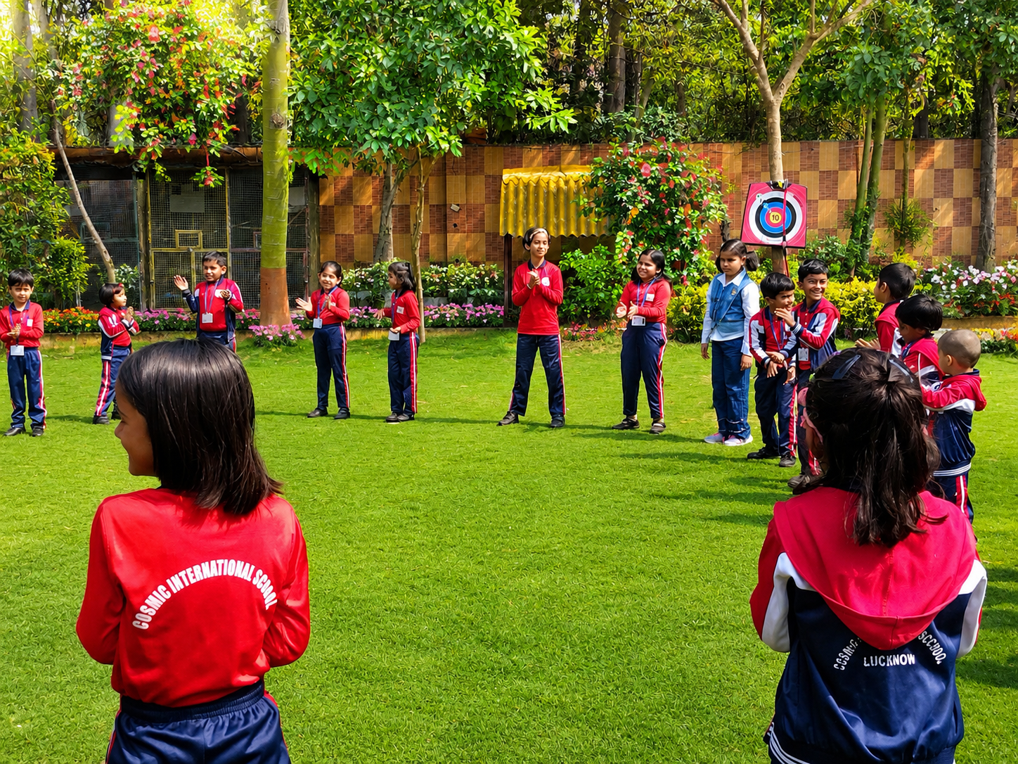 Students practising yoga outdoors with their teacher